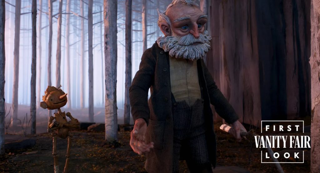 "Guillermo del Toro's Pinocchio" first look image 8, showing Pinocchio looking up hopefully at Geppetto in a dark forest.