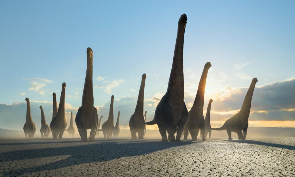 "Planète préhistorique" une capture d'écran montrant le troupeau de Dreadnoughtus au niveau du désert. 