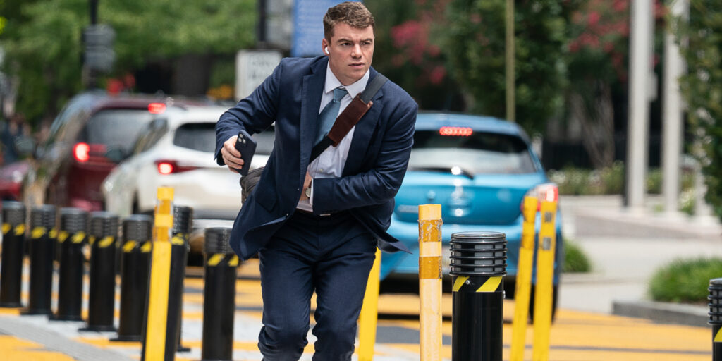 Gabriel Basso runs down a street in Washington DC in A House of Dynamite.