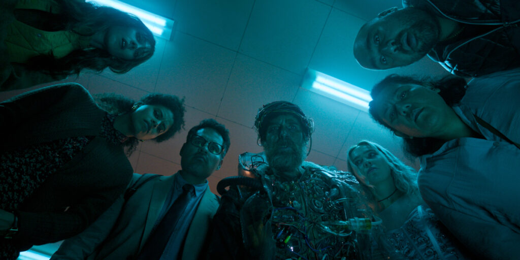Sam Rockwell and the cast look down at the camera with worry in Good Luck, Have Fun, Don't Die.