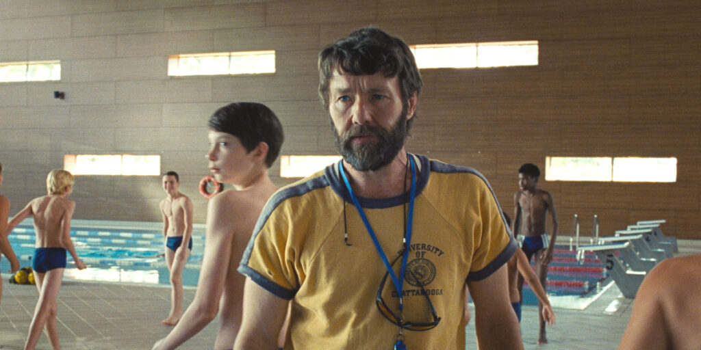 A worried Joel Edgerton walks forward as Everett Blunck anxiously looks back in The Plague.