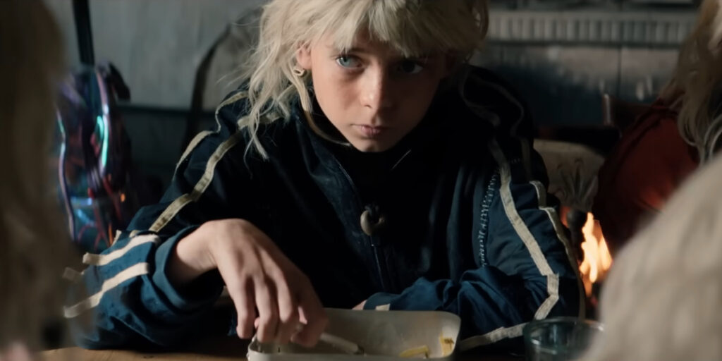 Alfie Williams looks up fearfully from his food bowl in 28 Years Later: The Bone Temple.