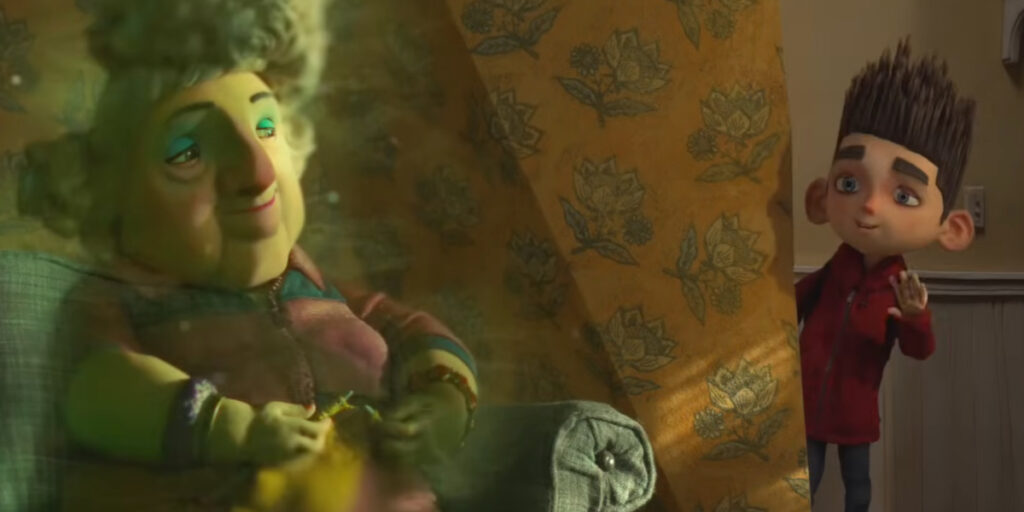 Norman waves happily at a ghost sitting in the living room in Paranorman.