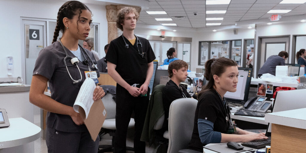 Laetitia Hollard, Lucas Iverson, Isa Briones, Gerran Howell all look forward with concern at the nurse's station in The Pitt S2.