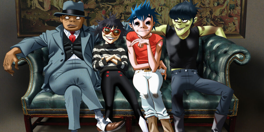 Gorillaz band members sitting on a couch for their press photo