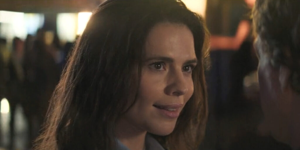 Hayley Atwell smiles slyly in a crowded setting in Mission Impossible: The Final Reckoning.