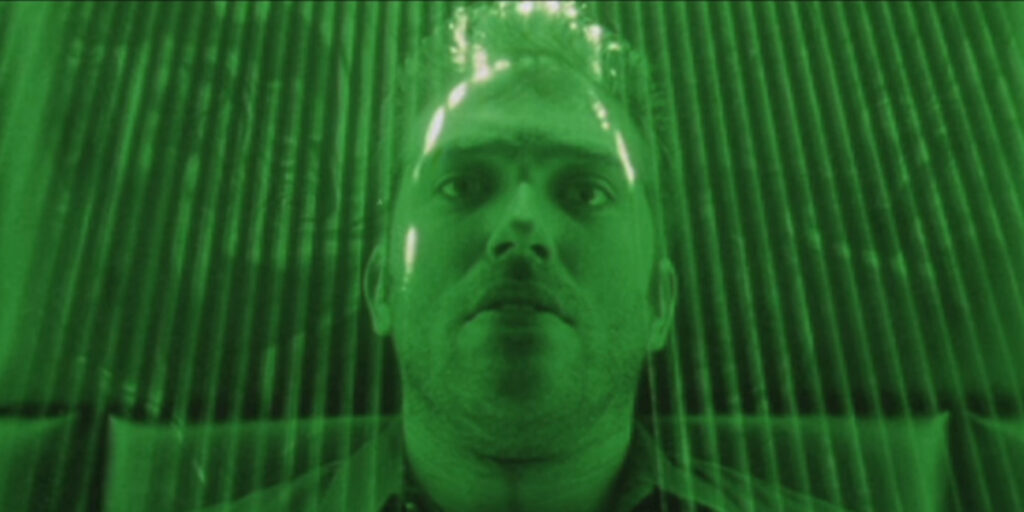 Craig Bierko lies in a green laser field in The Thirteenth Floor.
