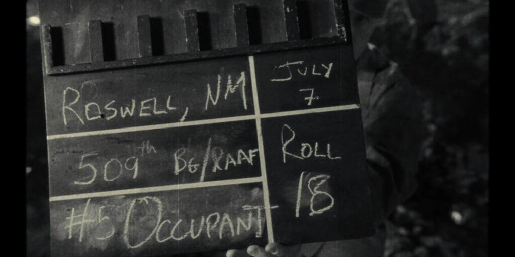 A clapboard being filmed during the Roswell Incident in Disclosure Day.
