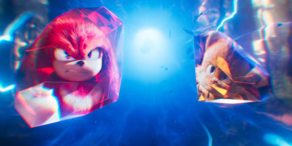 A distressed Knuckles and Tails depicted in the reflection of Chaos Emeralds in Sonic the Hedgehog 4's title reveal video.