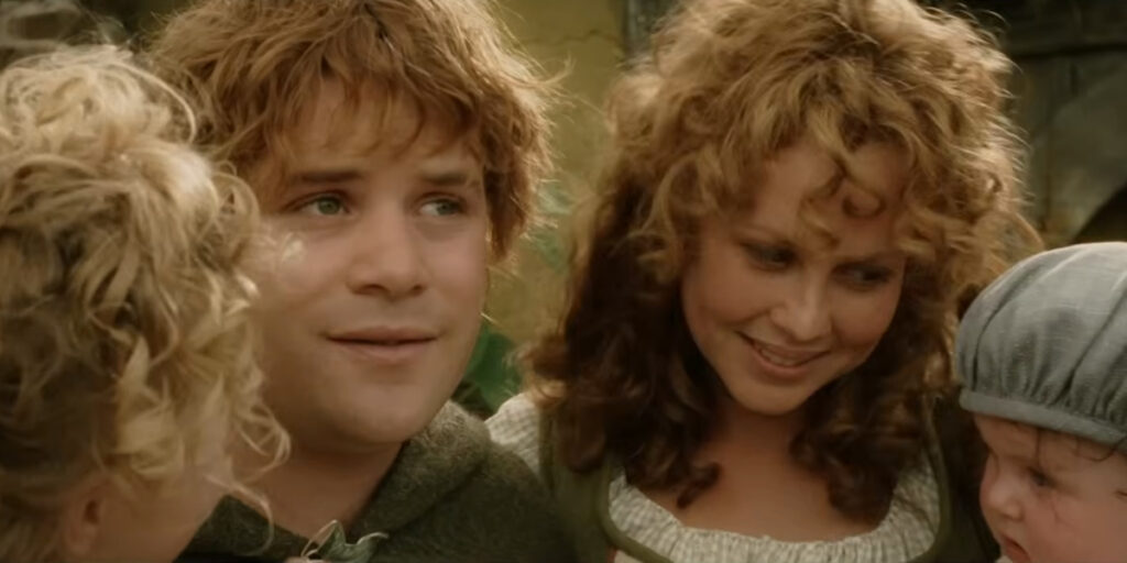 Sean Astin stands with a bittersweet expression with Sarah McLeod in The Lord of the Rings: The Return of the King.