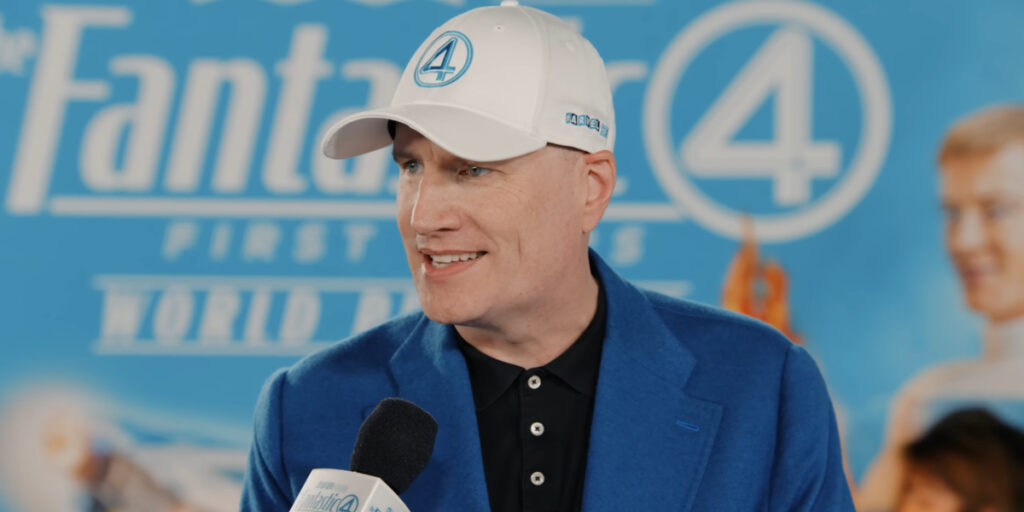 Kevin Feige stands in conversation on the blue carpet at The Fantastic Four: First Steps premiere.