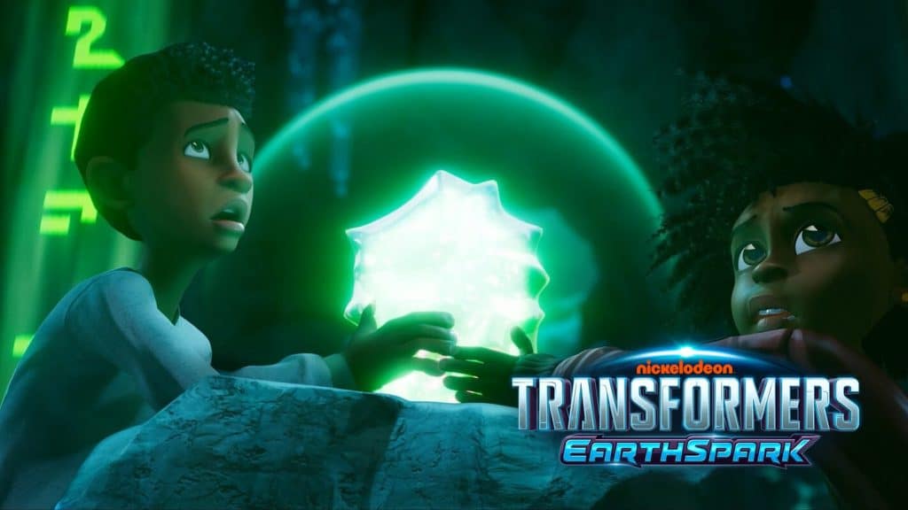 "Transformers: Earthspark" screenshot showing 2 black male characters clutching a big, glowing, green rock while staring at something else offscreen.