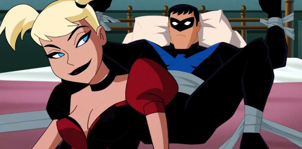 "Batman and Harley Quinn" screenshot showing Harley Quinn sitting on a bed in front of a bound Nightwing. Never thought I'd be writing this down.