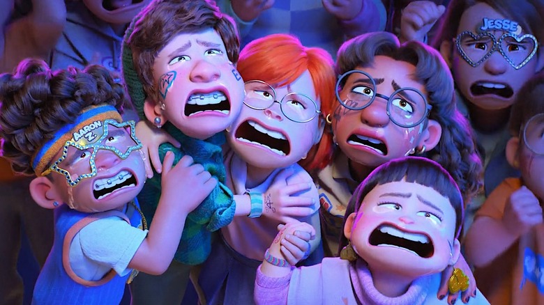 "Turning Red" screenshot showing Mei, her best friends, and Tyler gushing and crying tears of joy over 4*Town's live performance.