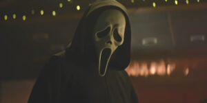 Ghost Face looms in a dimly lit room in Scream 7.
