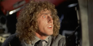 A wide eyed Roger Daltrey looks forward while bathed in light in The Who's Tommy.